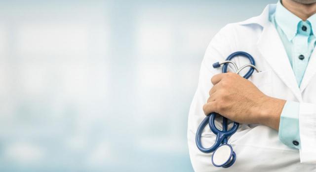 Doctor con hospital de fondo. Derecho a la salud
