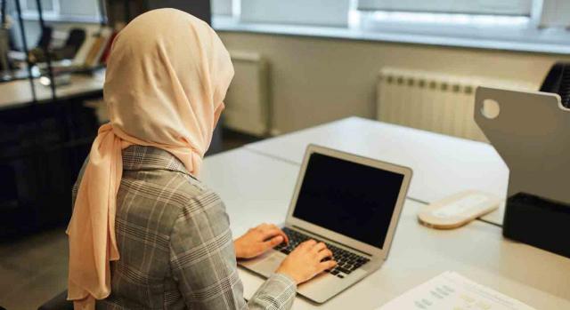 Símbolos religiosos en empresa privada. Mujer con hiyab trabajando frente a un ordenador