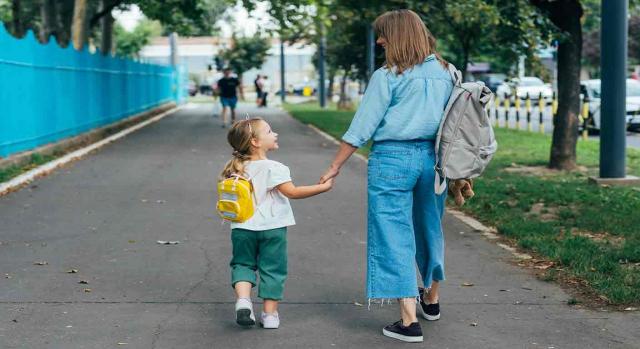 conciliación de la vida personal, laboral y familiar; adaptación de jornada; perspectiva de género e infancia. Una madre joven y su hija pequeña, caminan al colegio