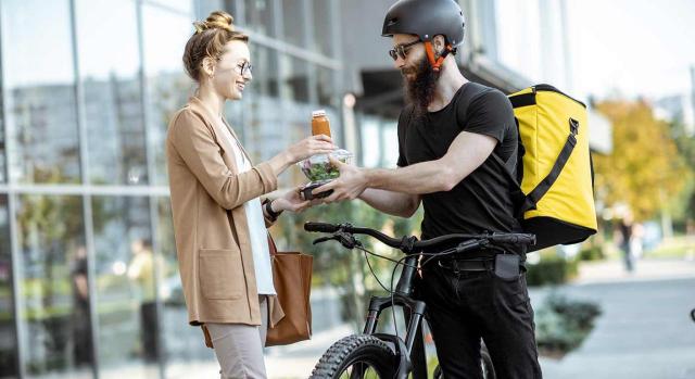 Recogida en el ET la presunción de laboralidad de las actividades de reparto. Imagen de Rider entregando comida a una trabajadora